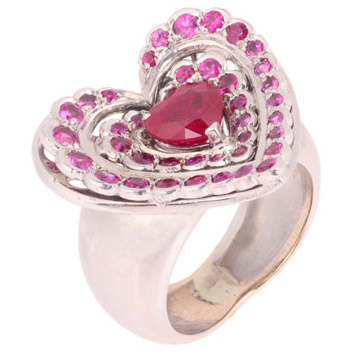 47 - NOURBEL - A Ruby Heart Ring,

set with a central heart cut ruby surrounded by two rows of round cut ... 