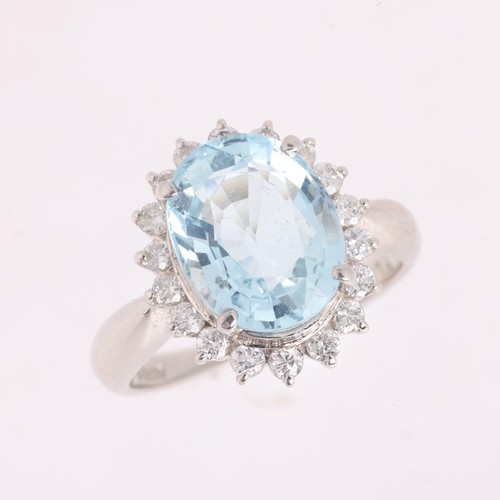 51 - An Aquamarine and Diamond Cluster Ring,

the oval cluster set with an oval mixed cut aquamarine weig... 