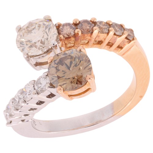 66 - A Cognac Diamond and Diamond Crossover Ring,

the terminals set with a modern round brilliant cut di... 