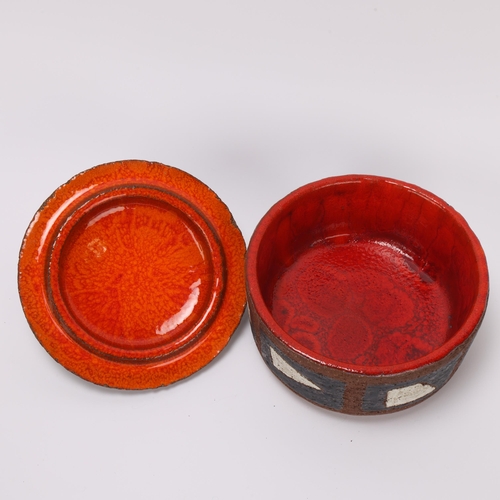 25 - A mid 20th century stoneware dish with matte outer glaze and red interior glaze, indistinct makers m... 