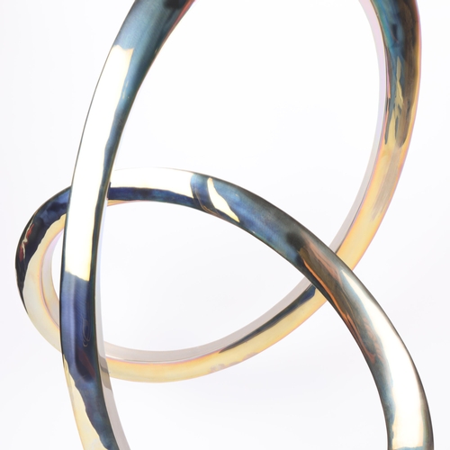 54 - A polished steel Infinity Curve sculpture on polished black granite base, height 58cm