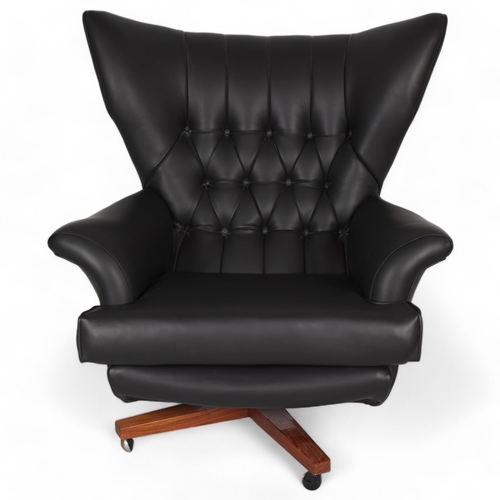 A G-Plan model 6250, "James Bond - Blofeld" armchair, designed 1960, recently professionally re-upholstered in sympathetic black faux leather, on teak swivel base, height 88cm
