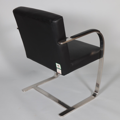 27 - A modern cantilever chair with polished steel frame and black leather upholstery and arm pads, heigh... 