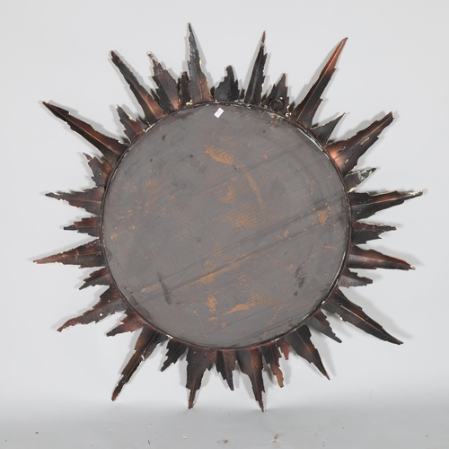 59 - A late 20th century welded steel and patinated sunburst mirror, diameter 90cm