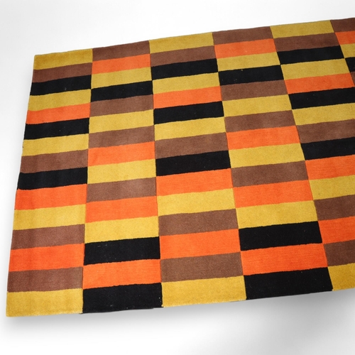 185 - A hand tufted wool rug in the design of the London Transport District Line moquette fabric, with mak... 