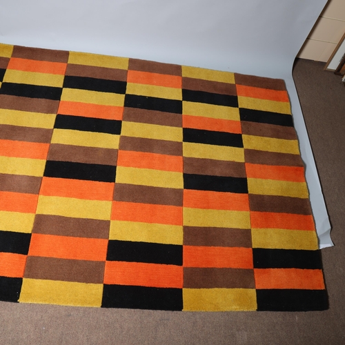 185 - A hand tufted wool rug in the design of the London Transport District Line moquette fabric, with mak... 