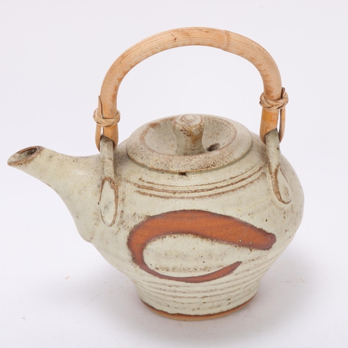 193 - A Mousehole Pottery, Cornwall stoneware teapot with cane handle, makers mark to base, length 19cm