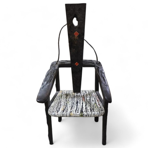 183 - TERRY WARREN, a hand made ebonised driftwood armchair, with marble painted seat and painted insert p... 