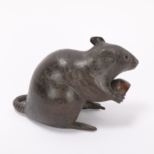 334 - A Chinese patinated bronze rat holding a nut, length 15cm, height 9.5cm