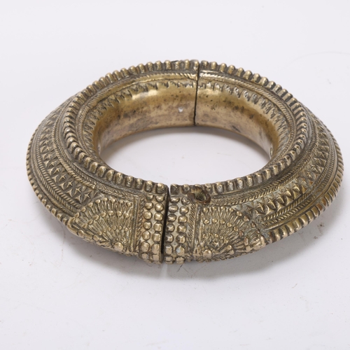 362 - A heavy cast-bronze 2-section slave bangle, diameter 15cm, and an 18th century bronze ball-shaped bo... 