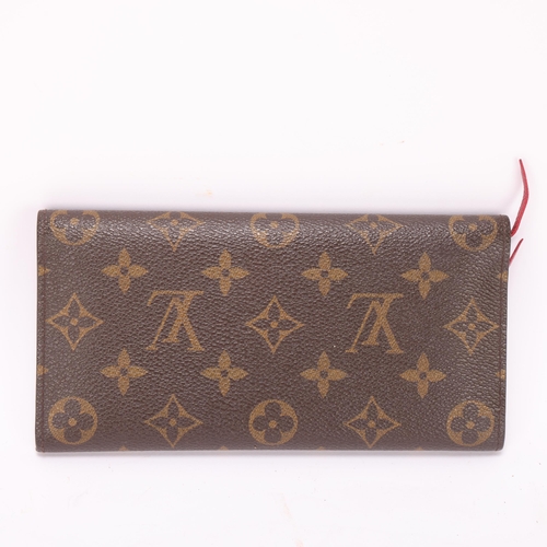 419 - A Louis Vuitton Sarah wallet, in brown monogram leather, with red leather covered leather and interi... 