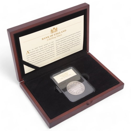 438 - A George III 1813 Three Shilling Bank Token, in sealed capsule, CPM Coins presentation box and certi... 