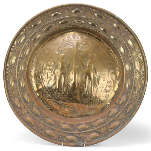 536 - An Antique brass alms dish, 17th or 18th century, depicting Adam and Eve, diameter 50cm