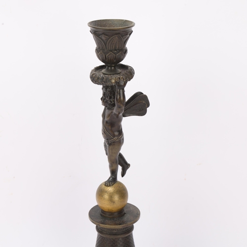 539 - A 19th century parcel-gilt bronze candlestick, supported by a cherub, height 32cm