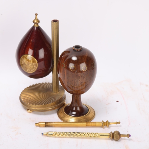 540 - Theo Faberge, 2 ornamental eggs, specimen wood and brass, largest height 14cm, together with a book