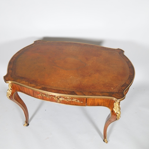 365 - A French walnut library table, early to mid-20th century, with shaped top, single frieze drawer on c... 