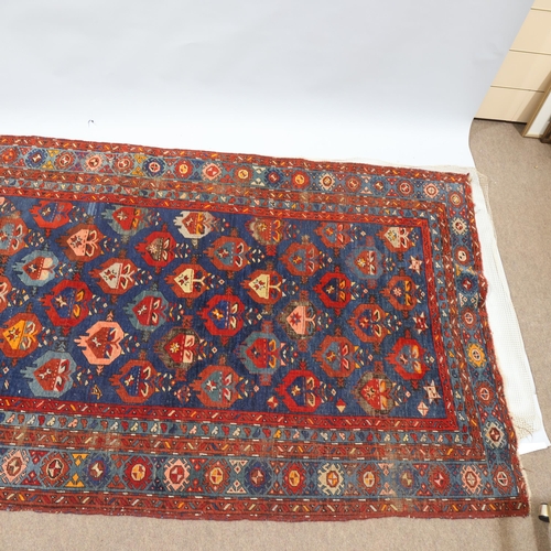 369 - An Antique Caucasian wool rug, blue/red ground, 148cm x 261cm