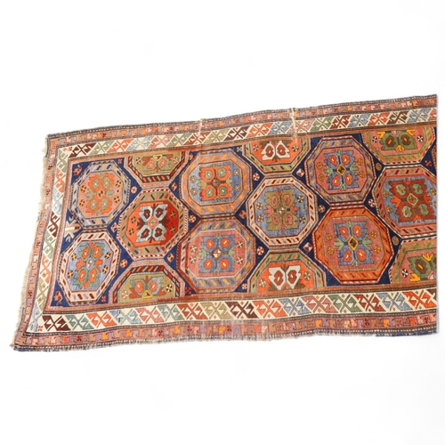 370 - A Persian Antique blue ground rug with multi-coloured lozenge centre panels, 113cm x 247cm