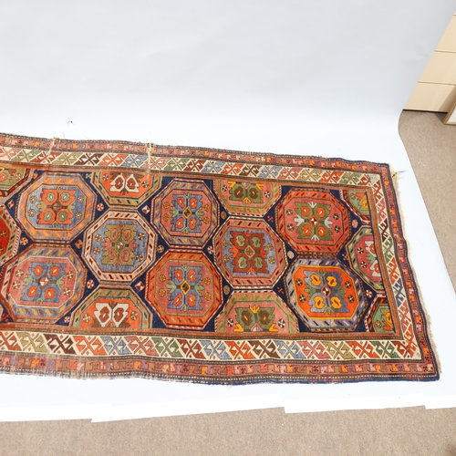 370 - A Persian Antique blue ground rug with multi-coloured lozenge centre panels, 113cm x 247cm