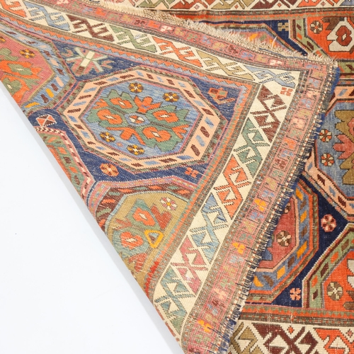 370 - A Persian Antique blue ground rug with multi-coloured lozenge centre panels, 113cm x 247cm