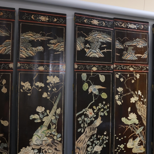 493 - A large Chinese relief carved and lacquered 8-section screen, early 20th century, height 213cm (7')