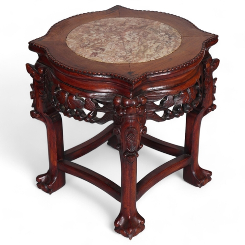 555 - A Chinese marble top jardiniere with carved hardwood frame, on ball and claw feet, height 46cm