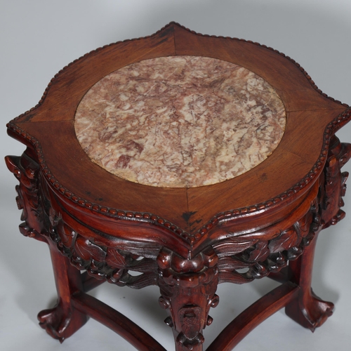 555 - A Chinese marble top jardiniere with carved hardwood frame, on ball and claw feet, height 46cm