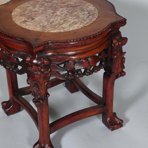 555 - A Chinese marble top jardiniere with carved hardwood frame, on ball and claw feet, height 46cm