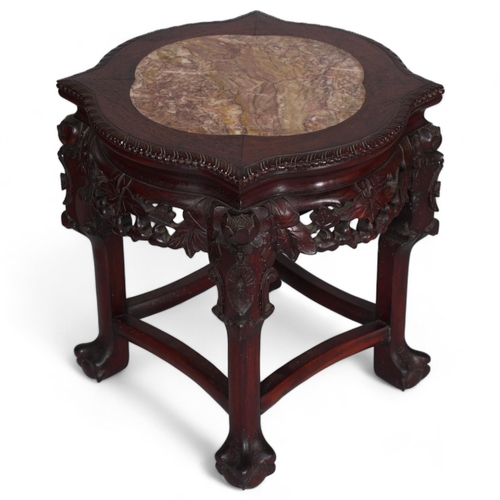 556 - A Chinese marble top jardiniere with carved hardwood frame, on ball and claw feet, height 46cm