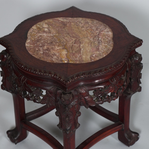 556 - A Chinese marble top jardiniere with carved hardwood frame, on ball and claw feet, height 46cm