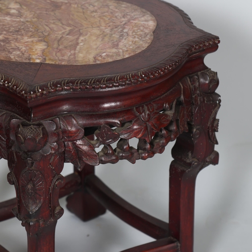 556 - A Chinese marble top jardiniere with carved hardwood frame, on ball and claw feet, height 46cm