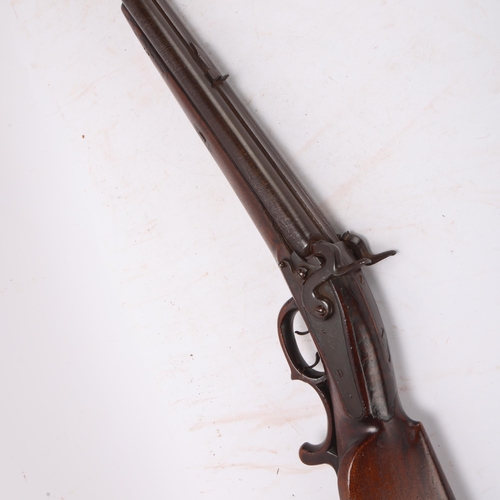 417A - A 19th century double-barrel percussion sporting gun, with carved stock and wood carved trigger guar... 