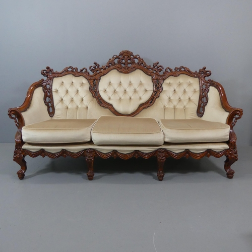 2109 - A Continental hardwood three piece suite, comprising a three-seater settee, 203x116x90cm and A pair ... 