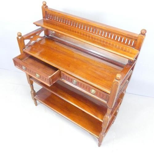 2116 - A continental mahogany three-tier buffet, with raised mirror back and two drawers, and carved and pi... 