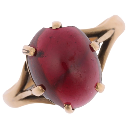 1292 - A 9ct gold garnet dress ring, claw set with oval cabochon garnet, setting height 10.8mm, size N, 3.3... 