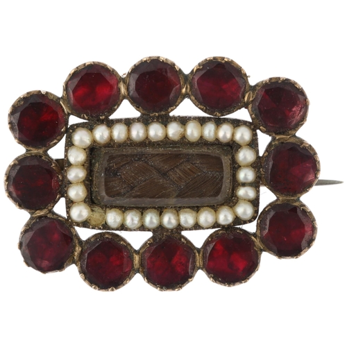 1303 - A Georgian flat-top garnet pearl and hairwork mourning brooch, circa 1820, central woven hair panel ... 