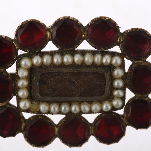 1303 - A Georgian flat-top garnet pearl and hairwork mourning brooch, circa 1820, central woven hair panel ... 