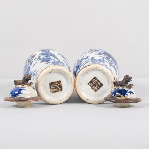 561 - A pair of Chinese blue and white jars and covers, with dog of fo knop and bird decoration, character... 