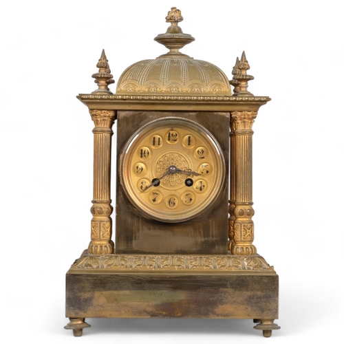 565 - A French 8-day brass architectural mantel clock, with Corinthian pillars to 4 corners, striking on a... 