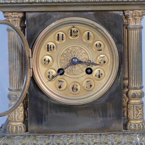 565 - A French 8-day brass architectural mantel clock, with Corinthian pillars to 4 corners, striking on a... 