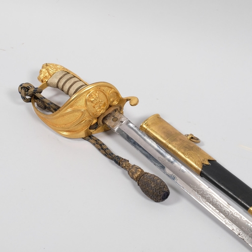 417G - A 20th British Naval Officer's sword, with gilt mounts and leather sheath, etched blade, no maker's ... 