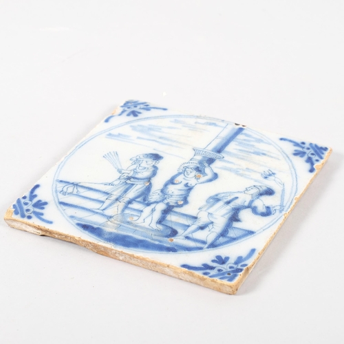 577A - An 17th/18th century delft tile depicting a flailing, 12.5cm sq