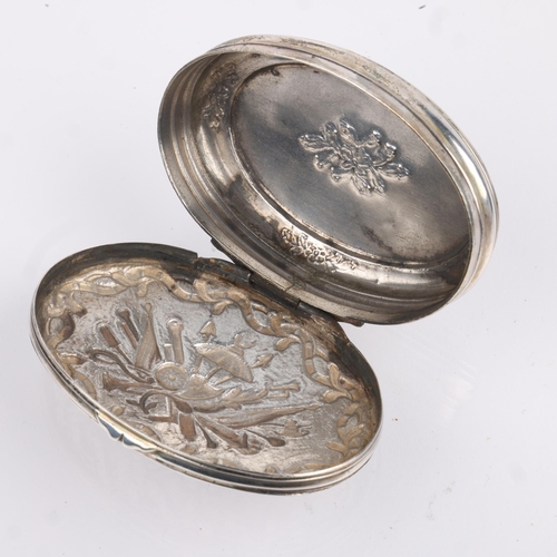 1469 - An 18th century Continental silver snuffbox, oval form with relief embossed weapon armaments decorat... 