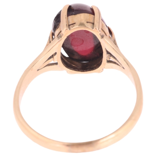 1292 - A 9ct gold garnet dress ring, claw set with oval cabochon garnet, setting height 10.8mm, size N, 3.3... 