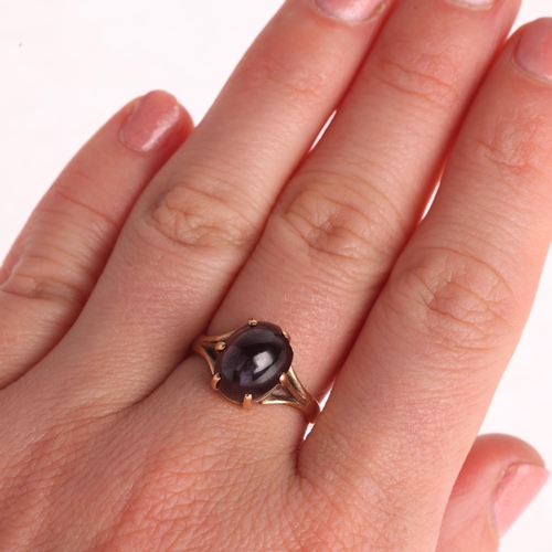 1292 - A 9ct gold garnet dress ring, claw set with oval cabochon garnet, setting height 10.8mm, size N, 3.3... 