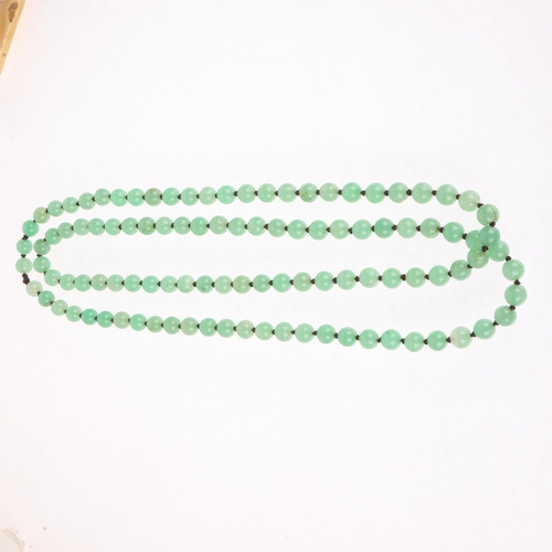 1307 - A single-row polished jadeite bead necklace, set with 12.2mm beads, 140cm, 242.8g