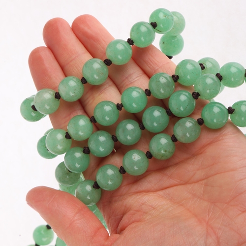 1307 - A single-row polished jadeite bead necklace, set with 12.2mm beads, 140cm, 242.8g