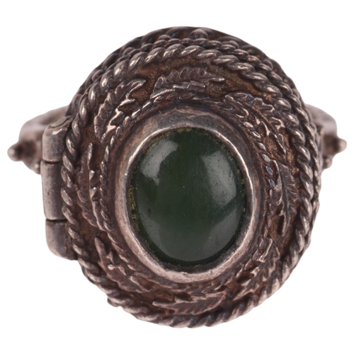 1339 - A sterling silver nephrite poison ring, with hinged top panel opening to reveal internal compartment... 