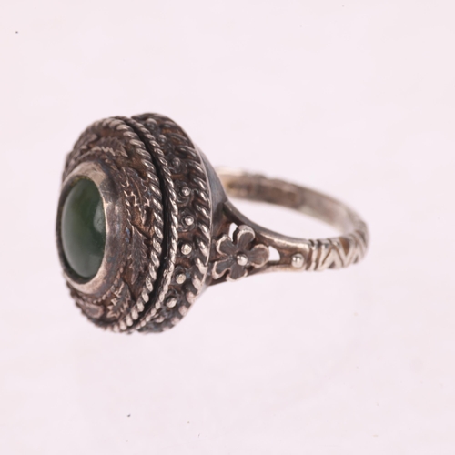 1339 - A sterling silver nephrite poison ring, with hinged top panel opening to reveal internal compartment... 