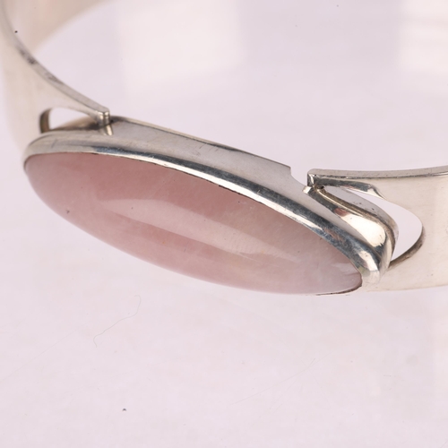 1354 - KAUNIS KORU OY - a Finnish modernist sterling silver rose quartz torque bangle, designed by Heikki K... 